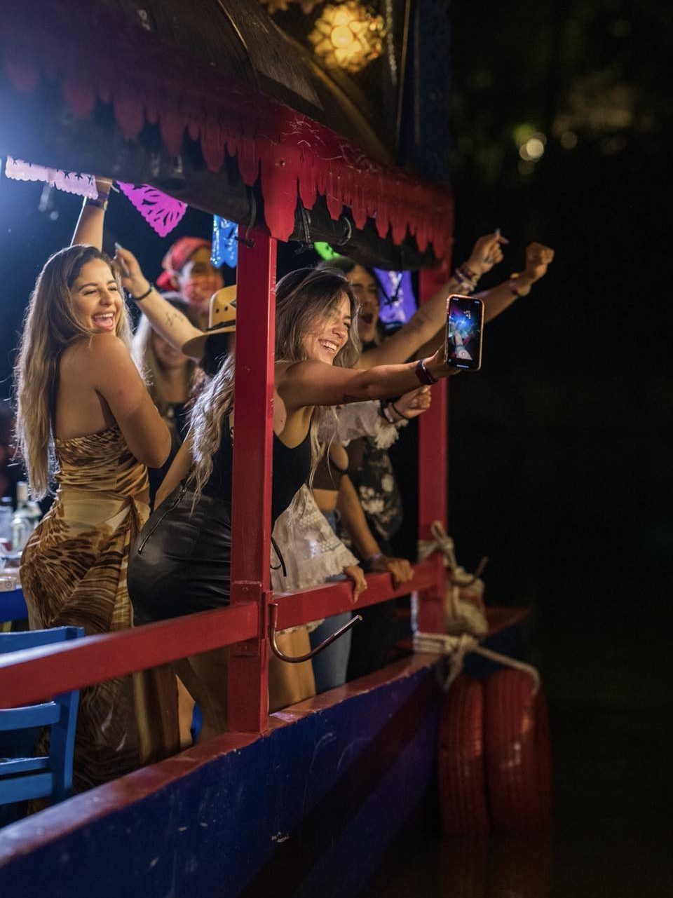 Festive scene with live musicians entertaining at Xoximilco